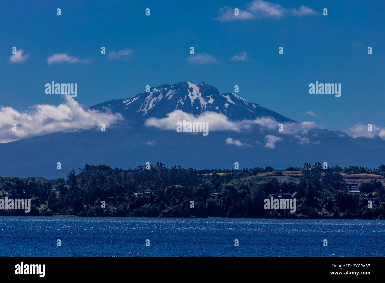 Vulcano Osorno in Cile. L'anello del fuoco cratere vulcanico e lava sulle pendici di un'alta montagna. Rocce rosse vulcaniche e picco innevato Foto Stock