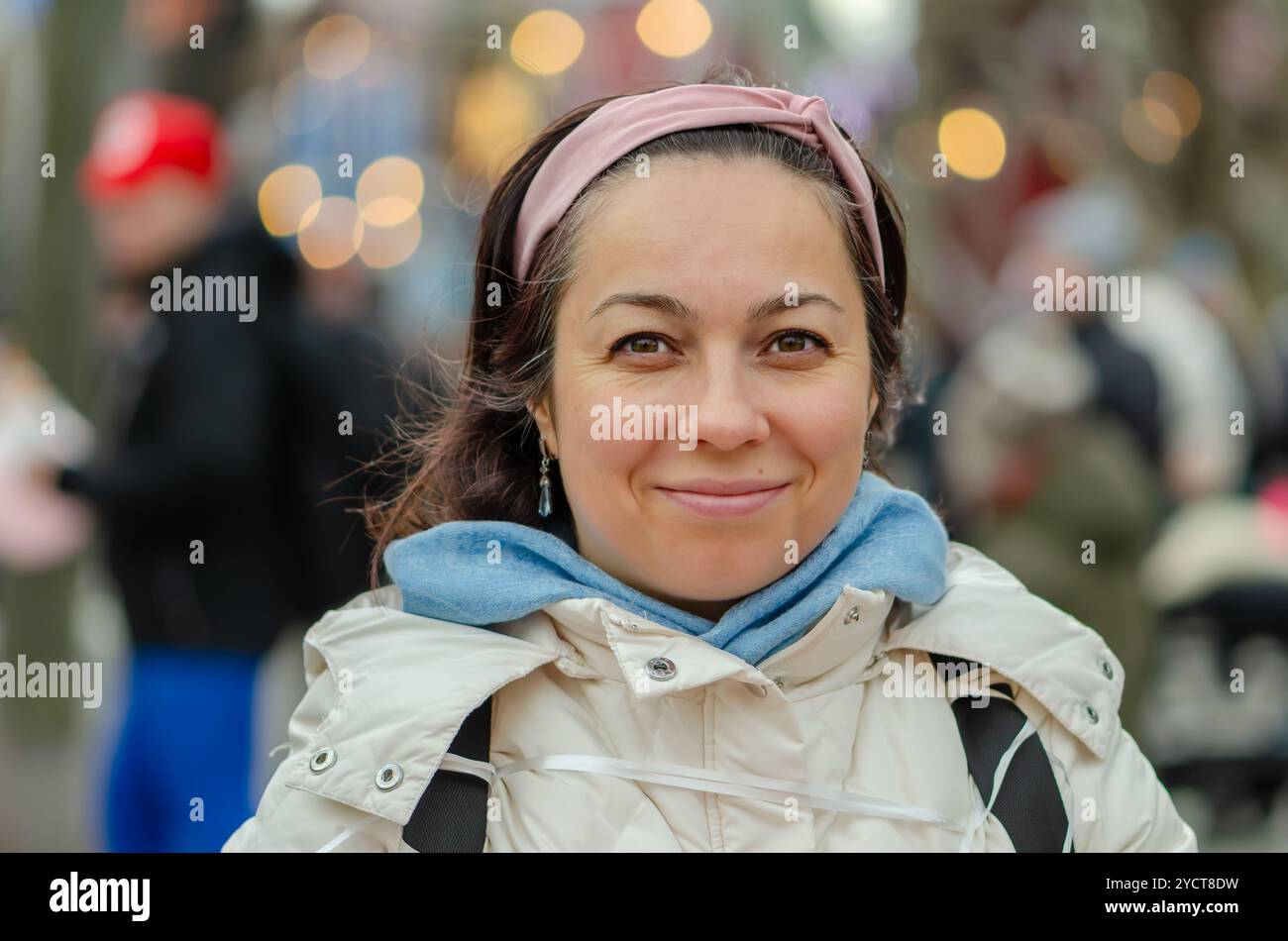 Bella donna dall'aspetto orientale di 40 - 45 anni sullo sfondo di un paesaggio urbano sfocato. Foto Stock