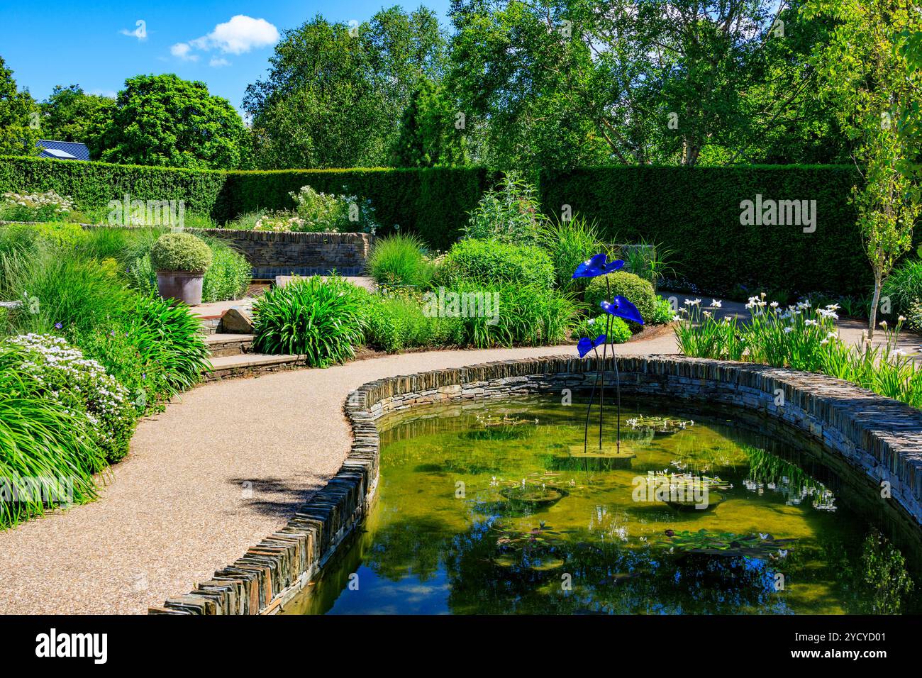 Sculture colorate e un torrente serpeggiante scorrono attraverso il nuovo Cool Garden presso il RHS Garden Rosemoor, Devon, Inghilterra, Regno Unito Foto Stock