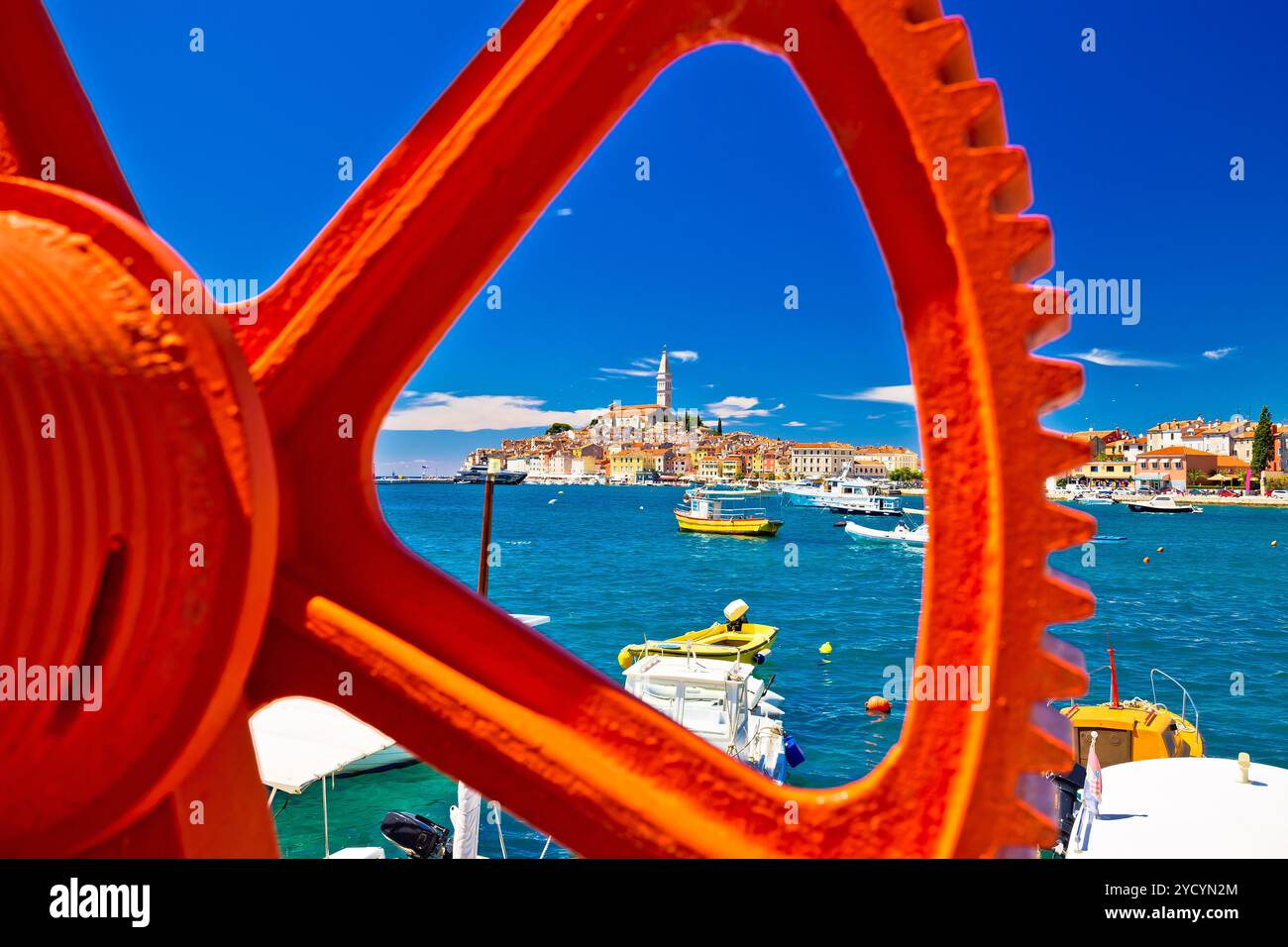 Vista sul lungomare della città di Rovigno attraverso la rampa di accesso per barche arrugginite Foto Stock