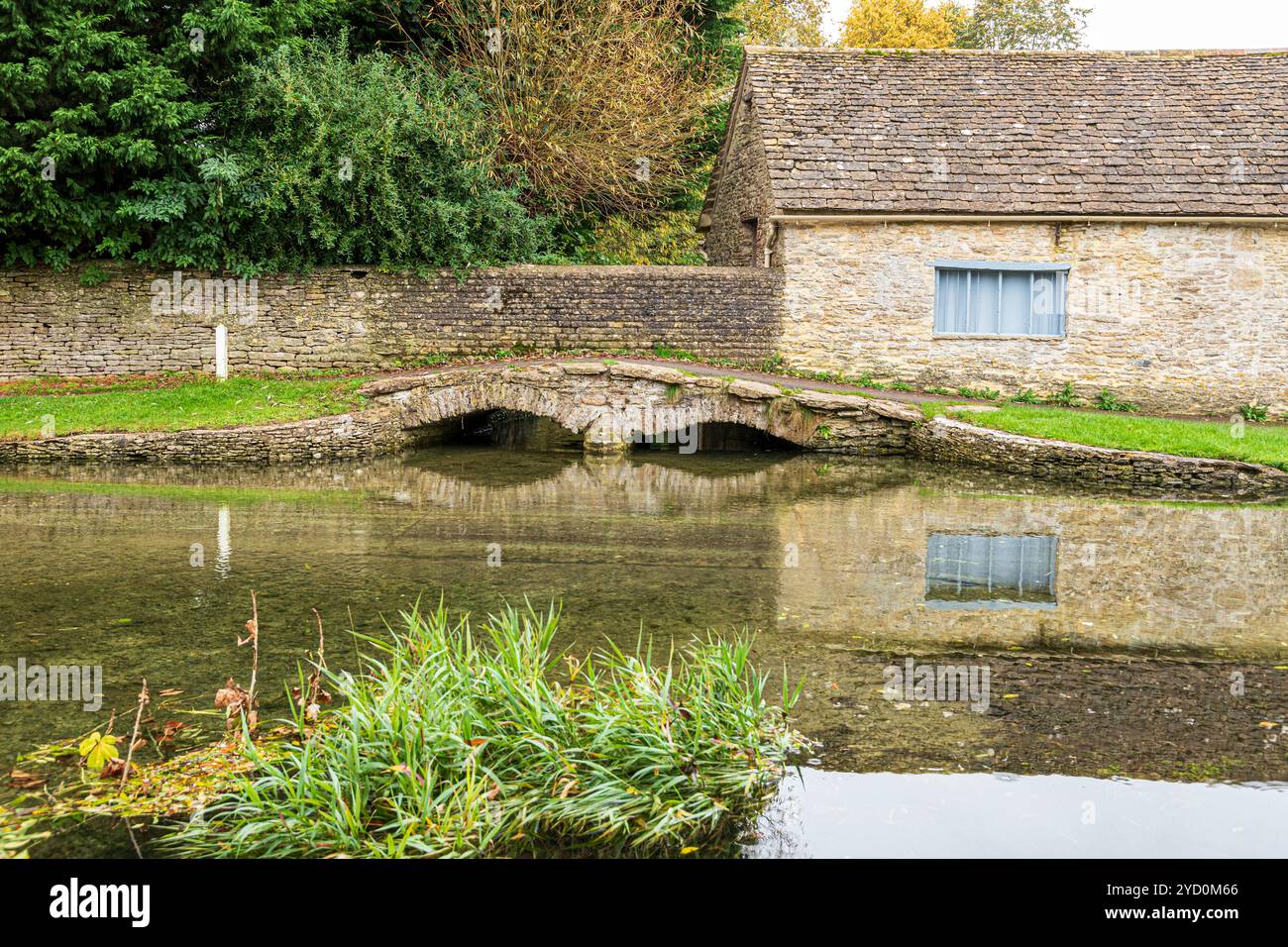Il Shill Brook piuttosto pieno di recenti forti piogge a Shilton Ford nel villaggio Cotswold di Shilton, vicino a Burford, Oxfordshire, Inghilterra Regno Unito Foto Stock