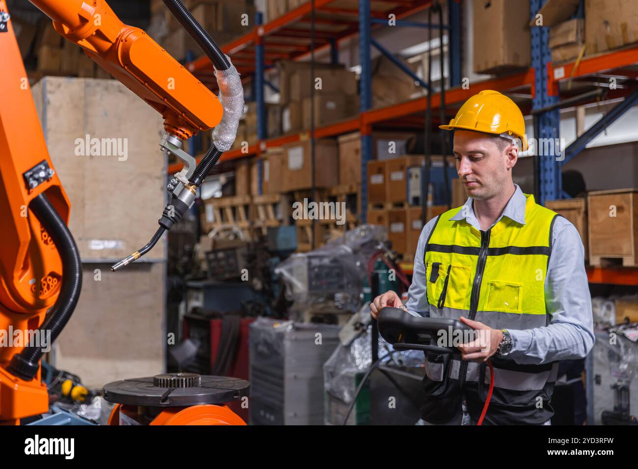 Progettazione di dispositivi di sicurezza che utilizzano un pannello di controllo per azionare un robot industriale in un magazzino di produzione. Concetto di tecnologia moderna, automazione Foto Stock