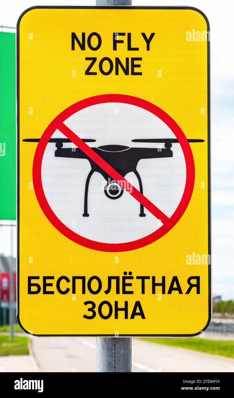 Cartello stradale con la scritta in inglese e russo: No fly zone, divieto di voli di droni Foto Stock Cartello stradale con la scritta in inglese e russo: No fly zone, divieto di voli di droni Foto Stock