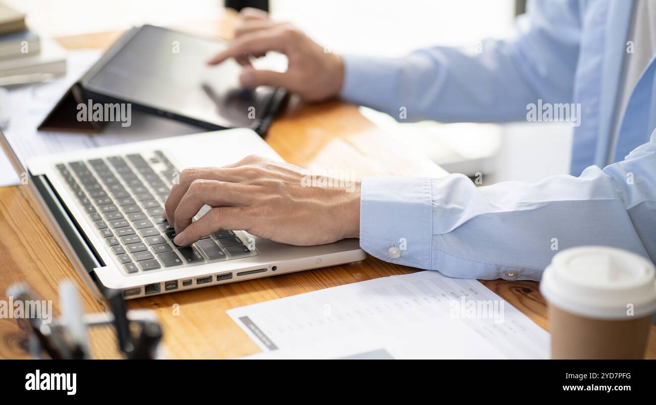 Uomo d'affari asiatico nel Data Mining Center Statistician con monitor che mostrano tecnologia e investimenti finanziari aziendali. S Foto Stock