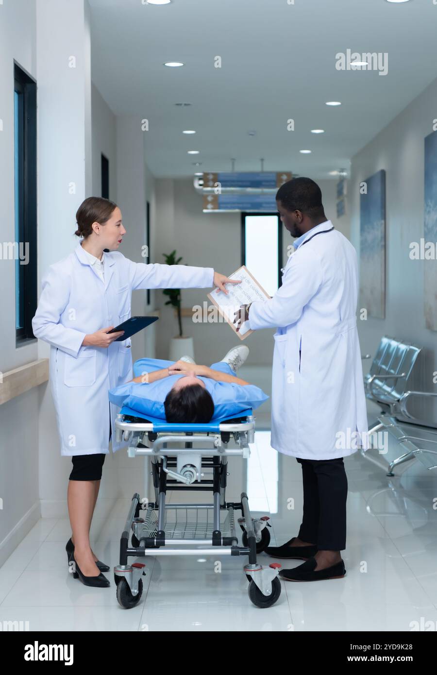 Professore di medicina e stagista che guarda una risonanza magnetica di un paziente che ha ricevuto una commozione cerebrale alla testa dopo un incidente. e informare Foto Stock