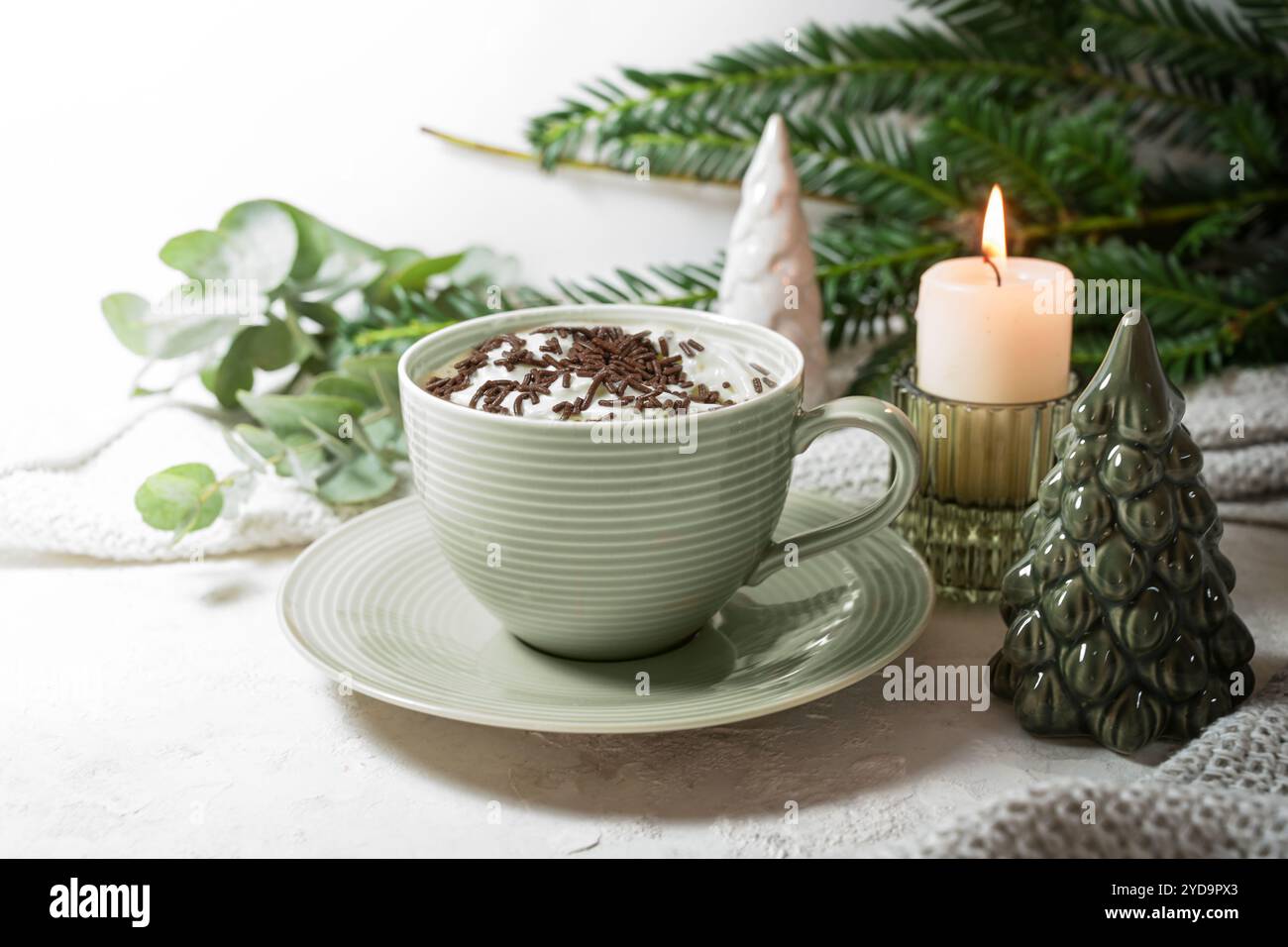 Tazza verde con cioccolata calda e panna montata, candela, ramoscelli e decorazioni natalizie su sfondo chiaro, bevanda dolce per giornate accoglienti a casa, copia Foto Stock Tazza verde con cioccolata calda e panna montata, candela, ramoscelli e decorazioni natalizie su sfondo chiaro, bevanda dolce per giornate accoglienti a casa, copia Foto Stock