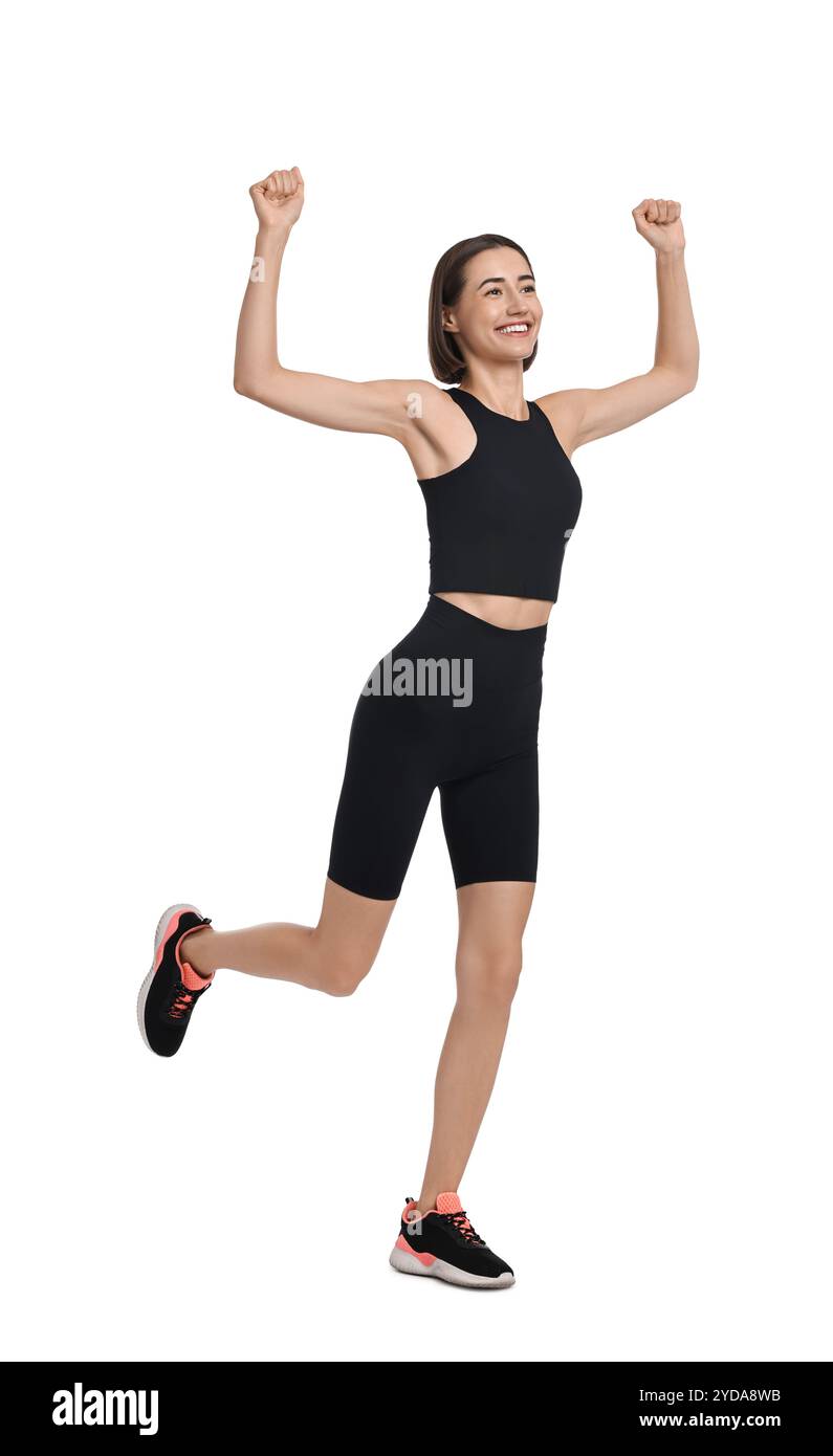 Bella donna in abbigliamento sportivo che corre su sfondo bianco Foto Stock