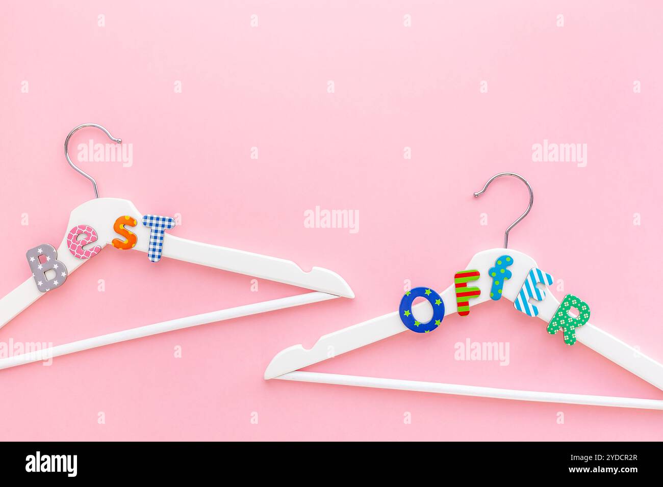 Appendiabiti bianchi con testo di vendita su sfondo rosa Foto Stock