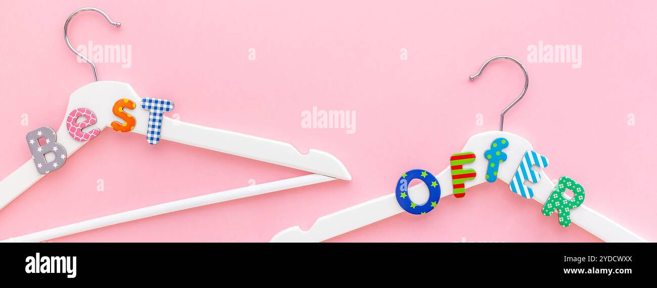 Appendiabiti bianchi con testo di vendita su sfondo rosa Foto Stock