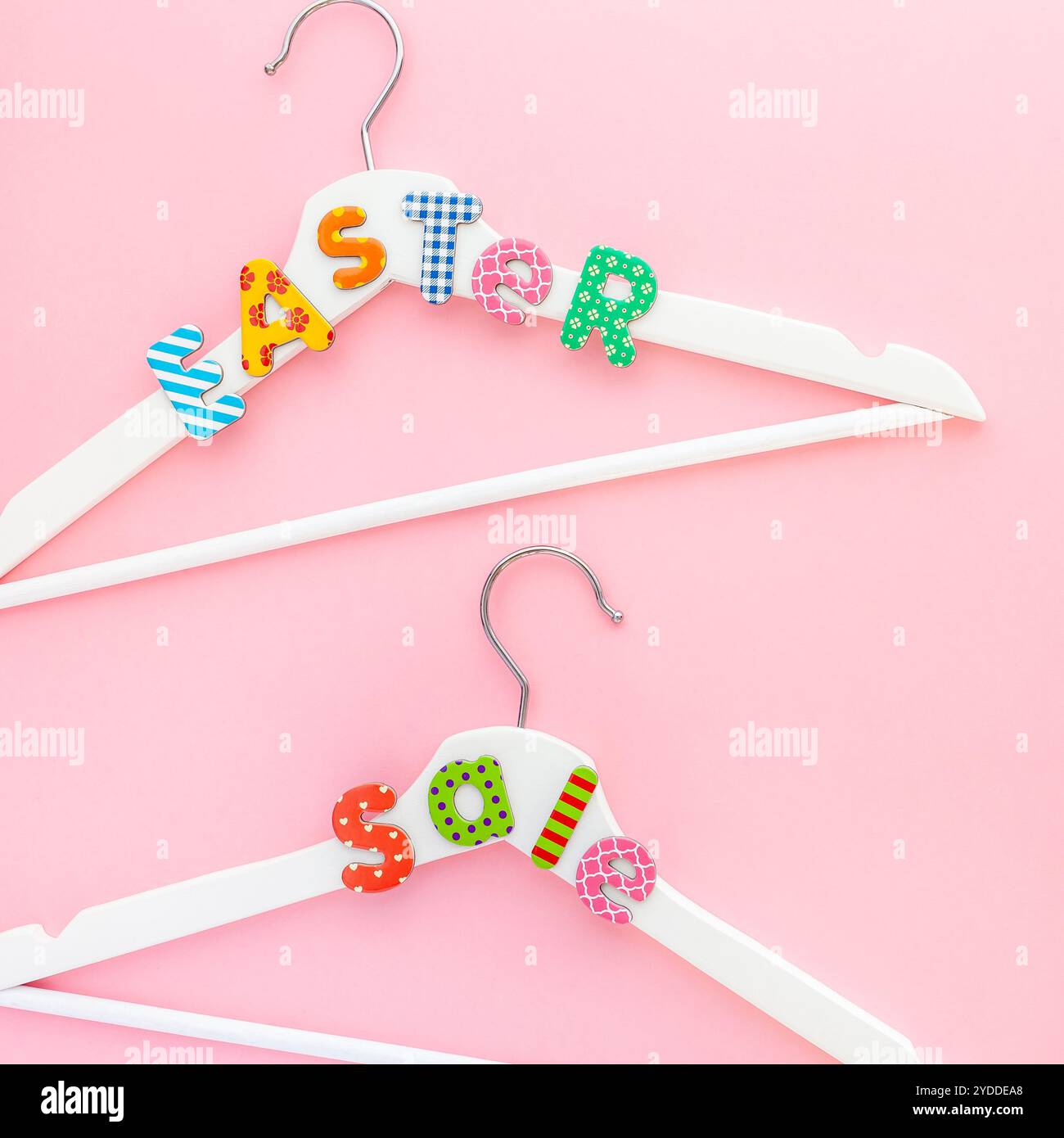 Appendiabiti bianchi con testo di vendita su sfondo rosa Foto Stock