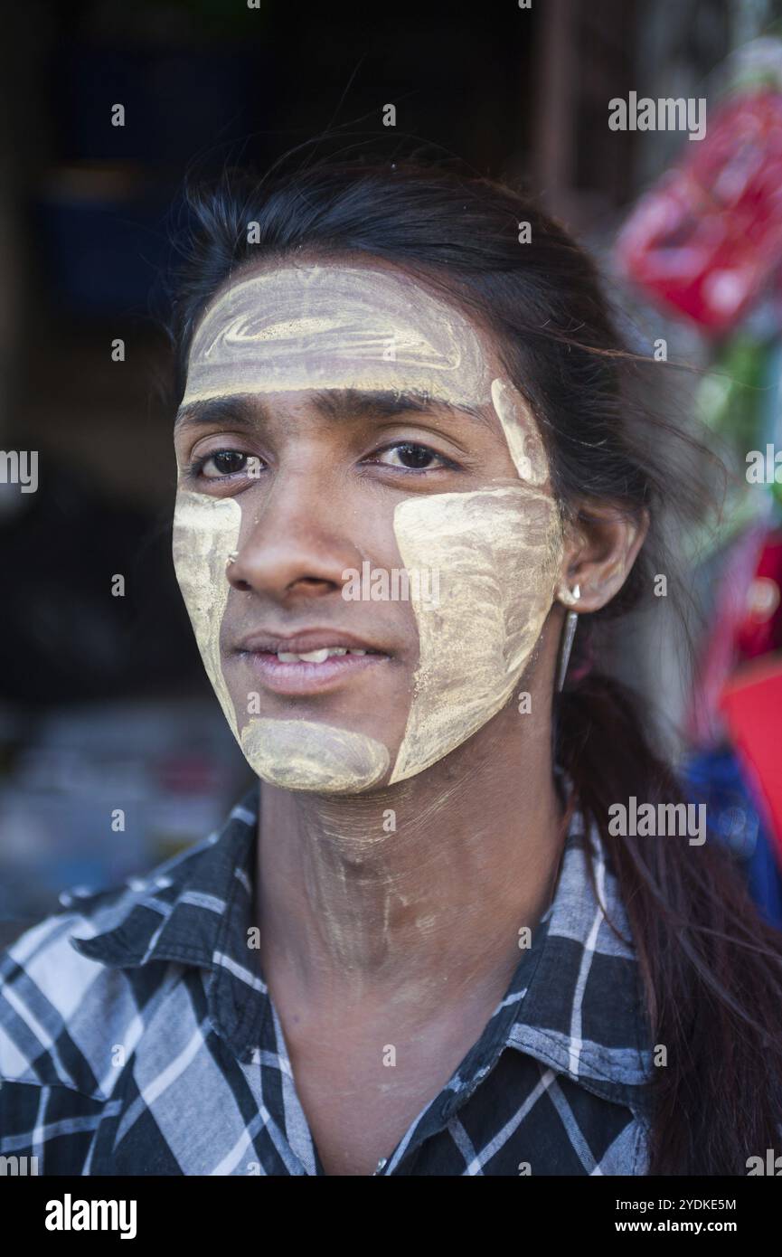 28.01.2017, Yangon, Myanmar, Asia, ritratto di un giovane uomo locale il cui volto è cosparso di pasta di thanaka. Il Thanaka è una pasta bianca giallastro prodotta da Foto Stock
