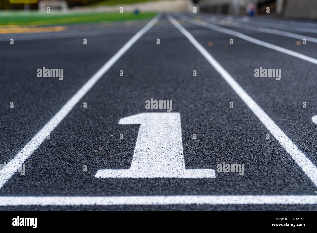 Avvicinati alla corsia numero 1 su una nuova pista da corsa nera con linee bianche e altre linee di demarcazione. Foto Stock