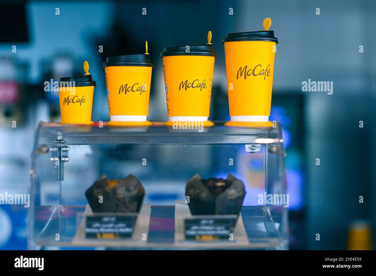 MASCATE - 19 SETTEMBRE: Vetrina con una fila di bicchieri di carta gialla per bevande calde al McCafe di Mascate il 19 settembre. 2024 in Oman Foto Stock