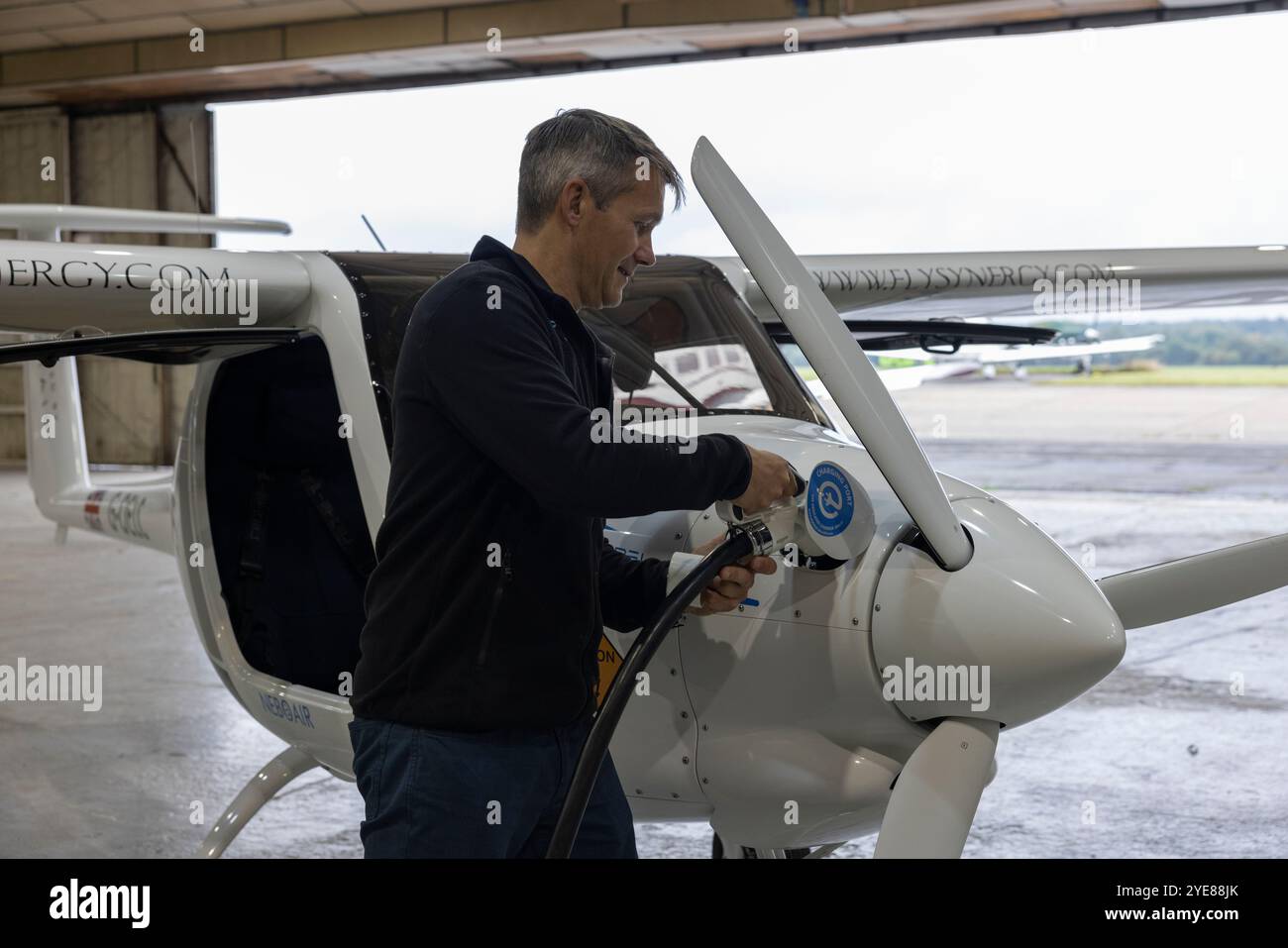 Ex pilota RAF Adam Twidell con il Pipistrel Velis Electro il primo aereo elettrico completamente certificato della Gran Bretagna, Fairoaks Airport, Surrey, Inghilterra Foto Stock