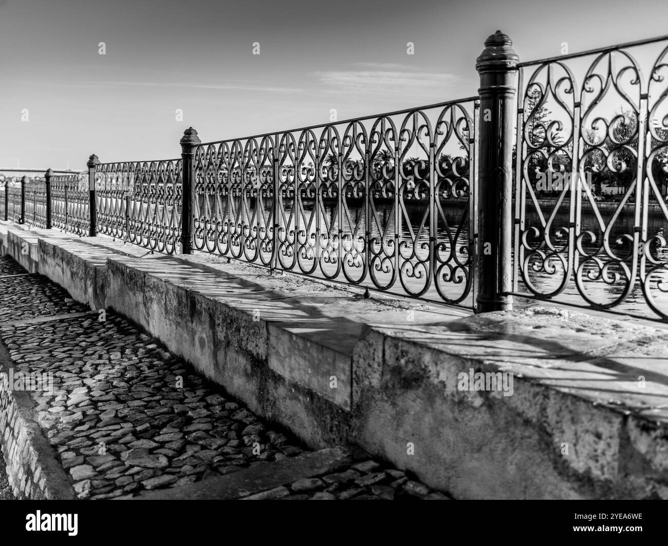 Recinzione decorativa in metallo lungo un lungomare nella città costiera di Tavira, Portogallo. Tavira è una piccola città sulla costa portoghese dell'Algarve a cavallo... Foto Stock