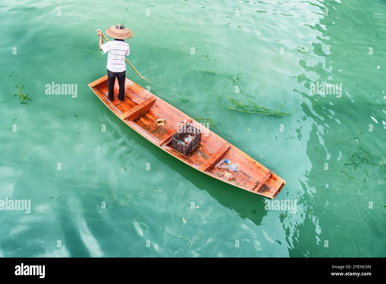 Incredibile vista dall'alto del barcaiolo asiatico in un tradizionale cappello di bambù Foto Stock