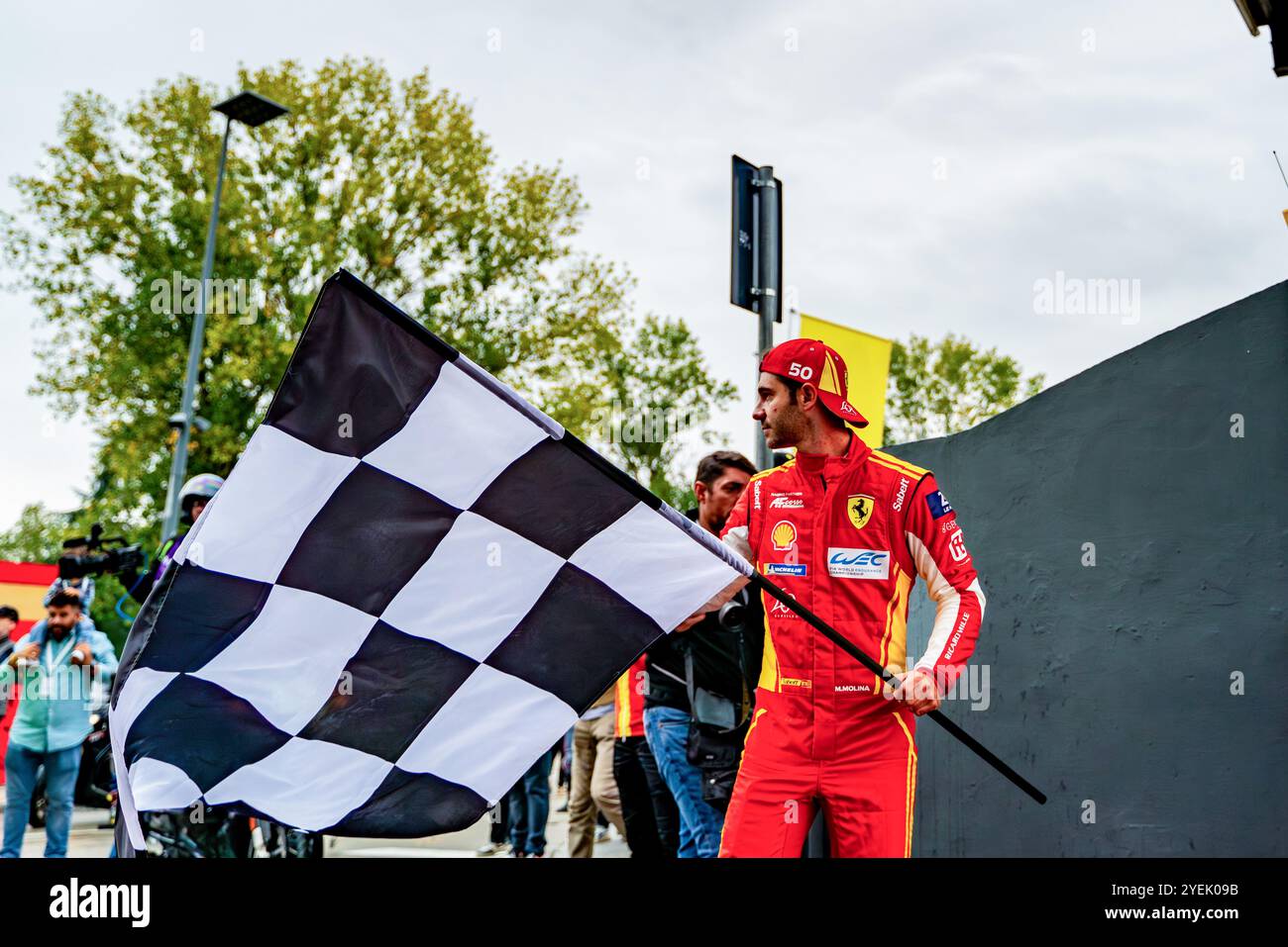 Miguel Molina (ESP) detiene la bandiera a scacchi poco prima di entrare in pista nella hypercar ferrari per la parata Ferrari durante i finali Ferrari Mondiali sul circuito internazionale Enzo e Dino Ferrari di Imola. Foto Stock