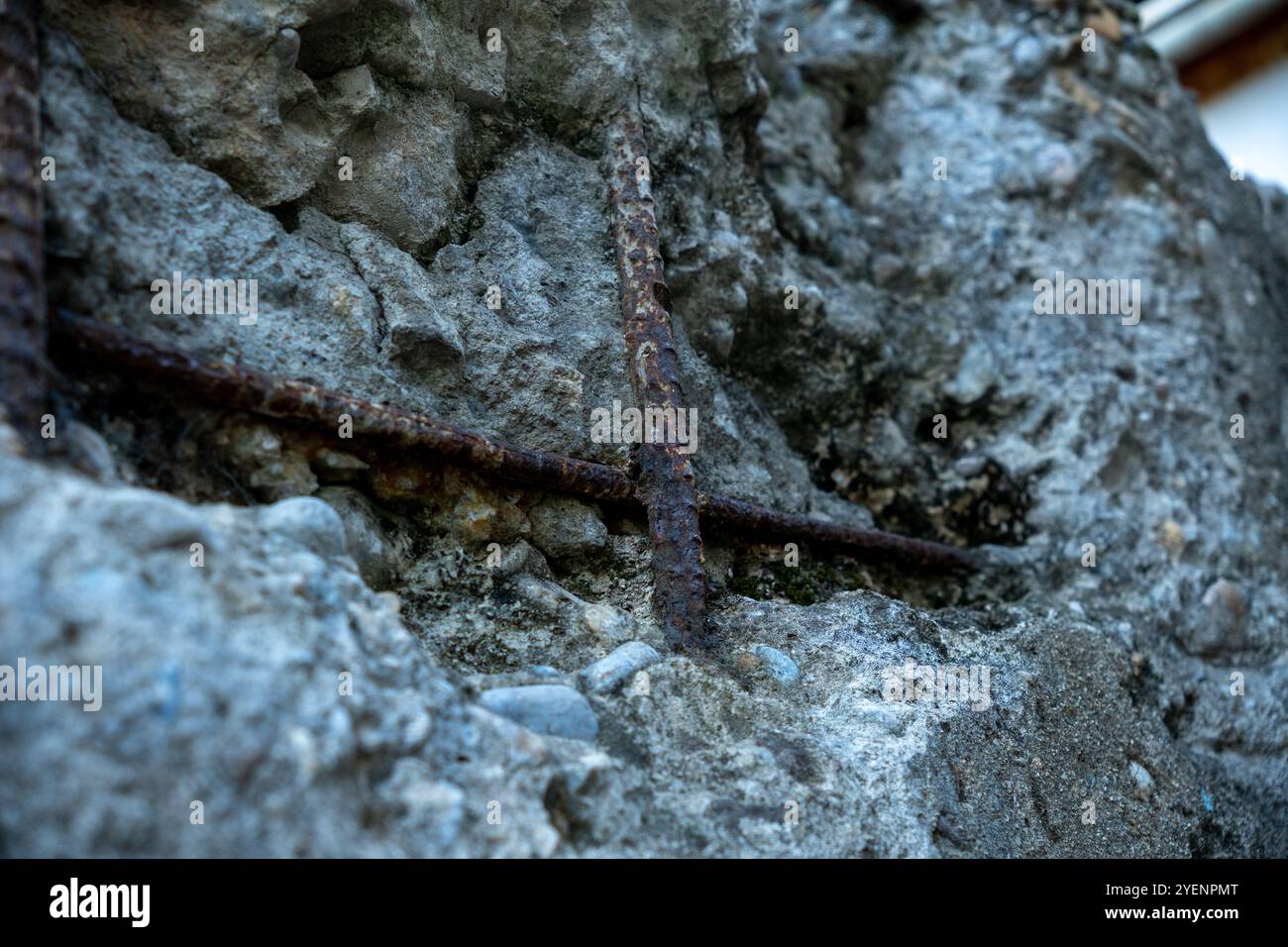 Barre di rinforzo esposte all'esterno di una parete di cemento rotta Foto Stock