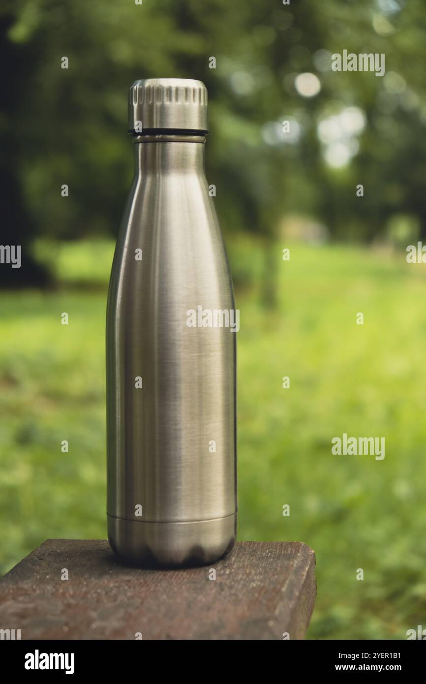 Bottiglia d'acqua. Bottiglia d'acqua termica riutilizzabile in acciaio su banco in legno. Stile di vita sostenibile. Senza plastica senza sprechi. Ambiente ecologico pro Foto Stock