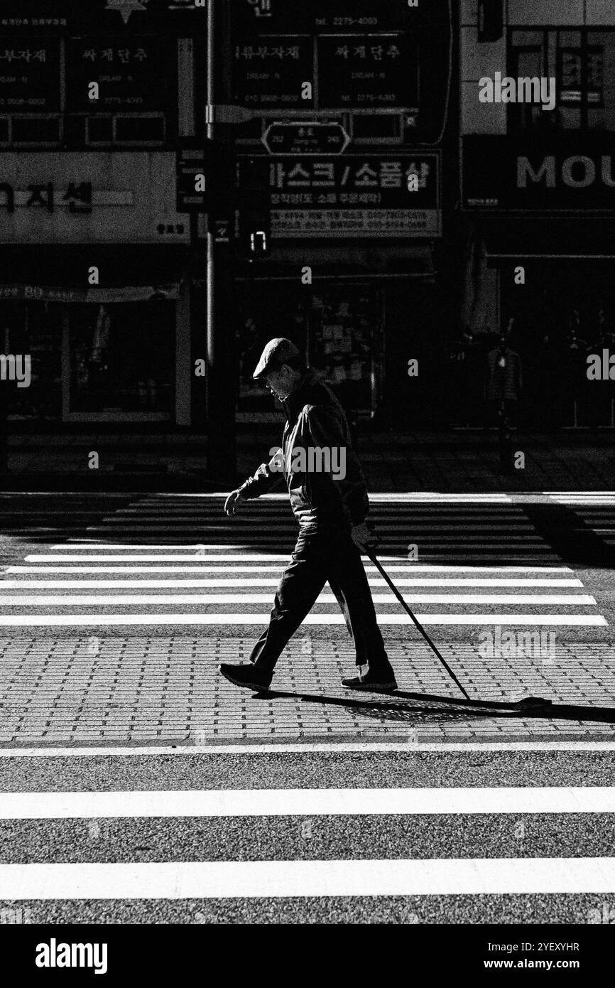 Uomo che cammina lungo la strada in Corea Foto Stock