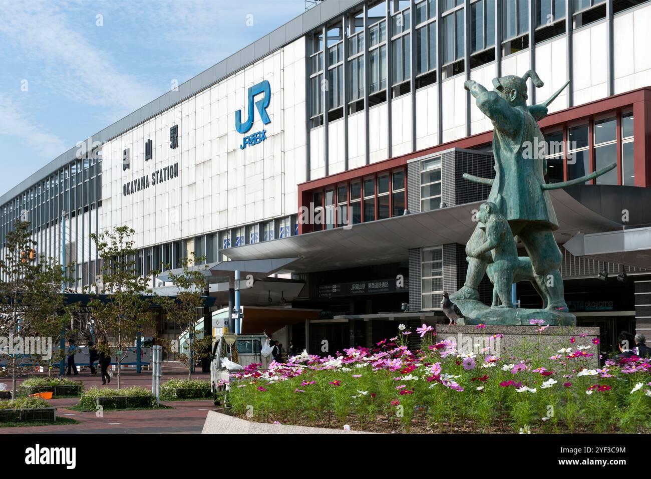 Statua di Momotaro eroe giapponese nel folklore accompagnato da una scimmia, un fagiano e un cane fuori dalla stazione ferroviaria di Okayama. Foto Stock