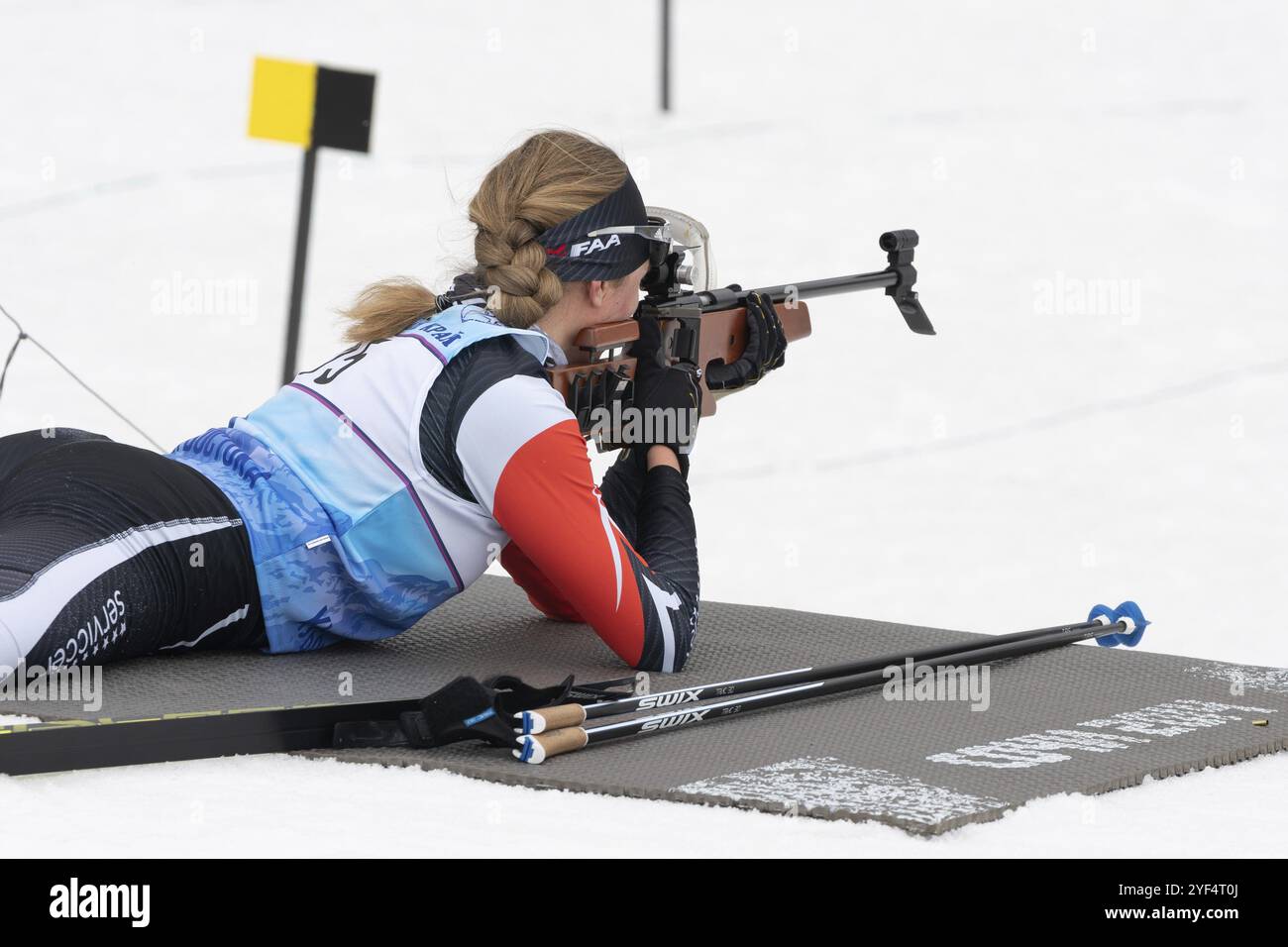 Sportiva biatleta Elizaveta Eremeeva fucile che spara in posizione prona. Biatleta nel poligono di tiro delle gare regionali Open di biathlon giovanile EA Foto Stock