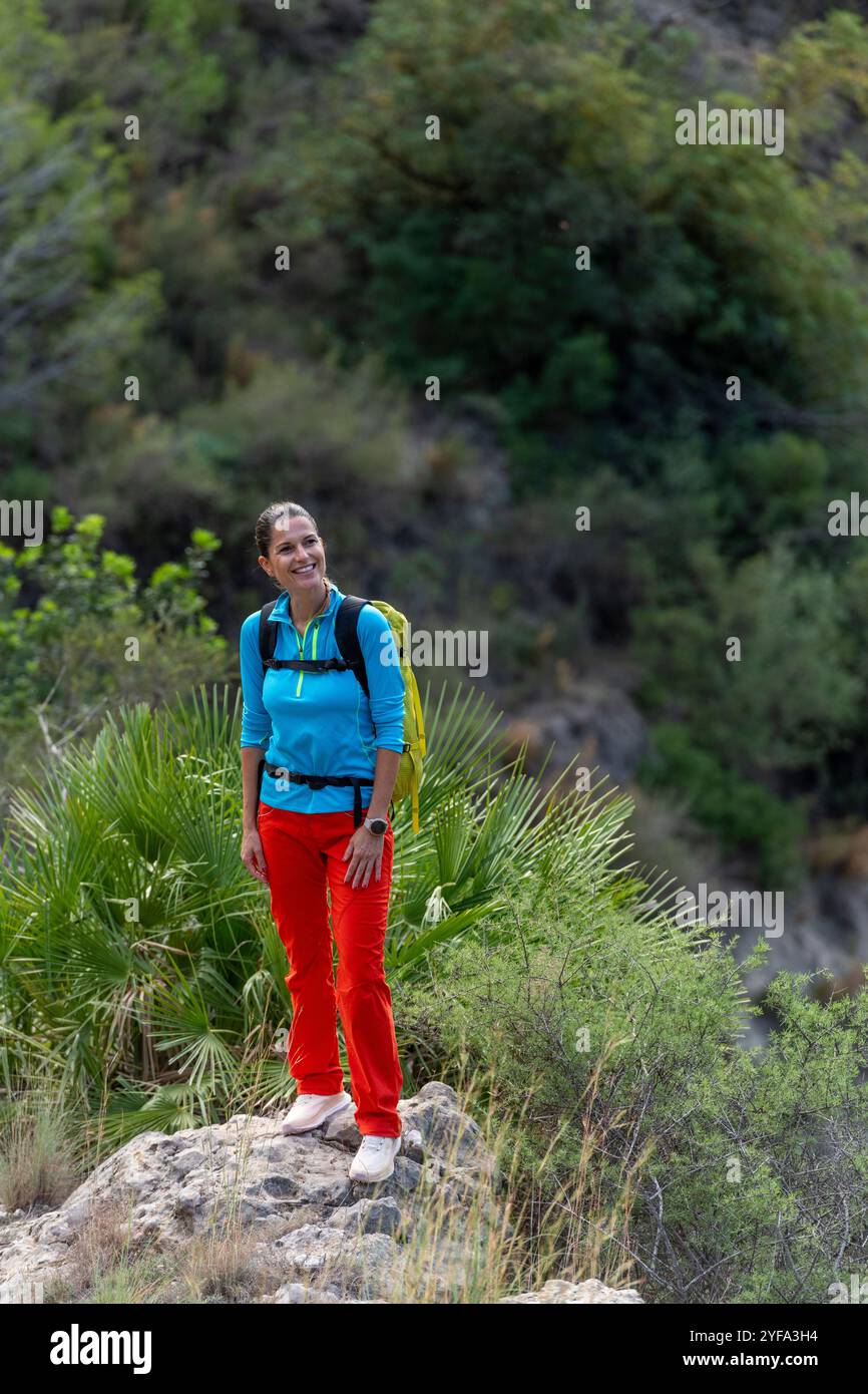 Donne con coloratissime attrezzature da esterno che camminano nella natura Foto Stock