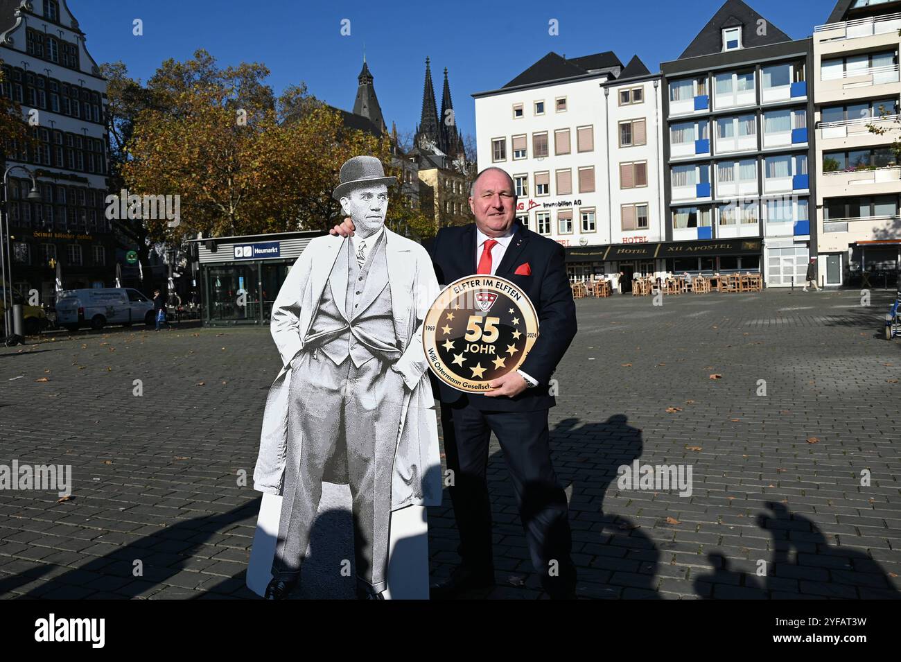 Präsident der Willi Osterman Gesellschaft Ralf Schlegelmilch posiert mit einem Standbild des Komponisten Willi Ostermann auf dem Kölner Heumarkt. Seit 55 Jahren organisiert die Willi-Ostermann-Gesellschaft den Kölner Karneval Sessionsauftakt am 11.11. In der Altstadt *** il presidente della Willi Osterman Society Ralf Schlegelmilch posa con una statua del compositore Willi Ostermann su Colognes Heumarkt da 55 anni, la Willi Ostermann Society organizza il lancio della stagione carnevalesca di Colonia nel 11/11 nella città Vecchia Foto Stock