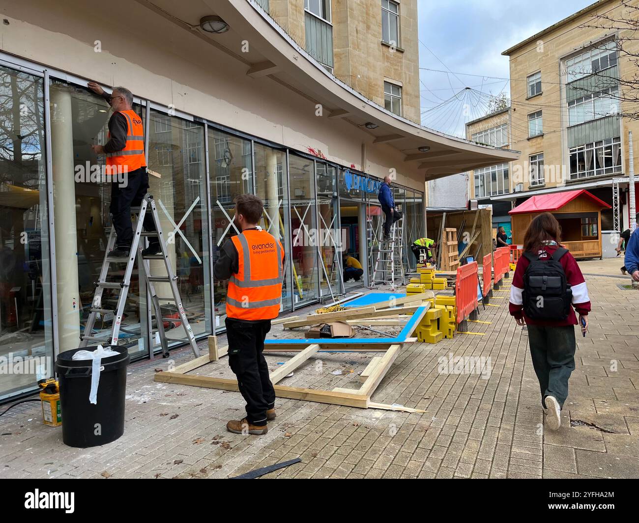 Lavori di riparazione in corso della Barclays Bank a Bristol, che è stata attaccata dagli attivisti dell'azione palestinese, che hanno distrutto il vetro e spruzzato vernice rossa. Foto Stock