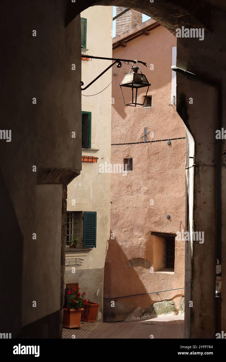 Vista su una stretta strada secondaria in una città vecchia, l'Umbria, Italia Foto Stock