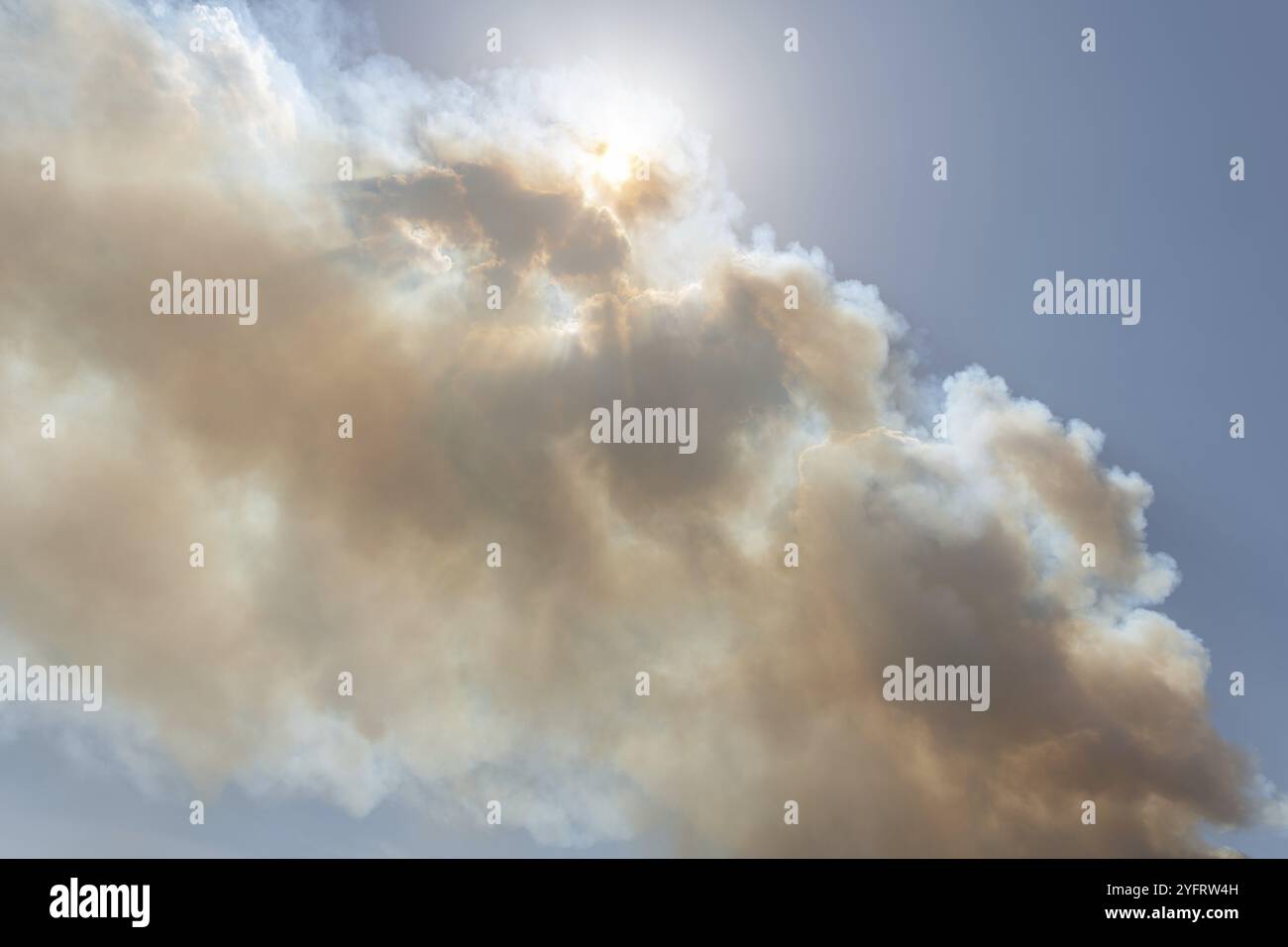 Nube di fumo da un grande incendio boschivo che passa davanti al sole. Montuejols, Aveyron, Cevennes, Francia, Europa Foto Stock