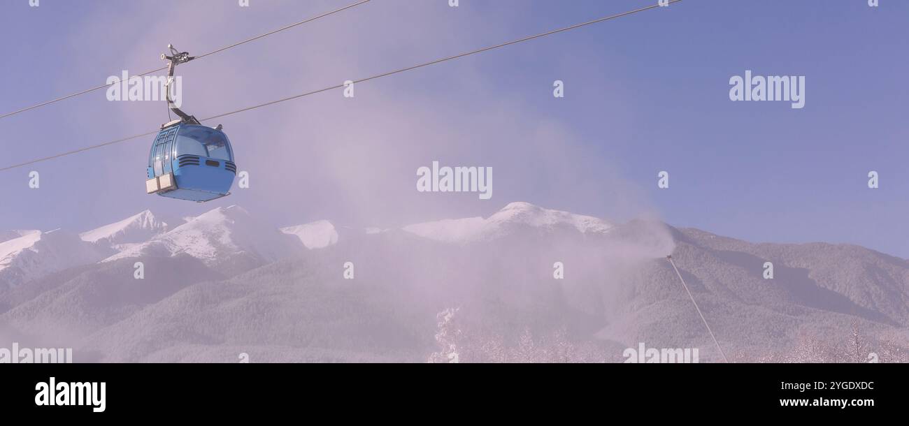 Bansko, Bulgaria banner stazione sciistica invernale con cabine di cabinovia blu, pinete foresta, vista sulle cime del Pirin e pendenza Foto Stock