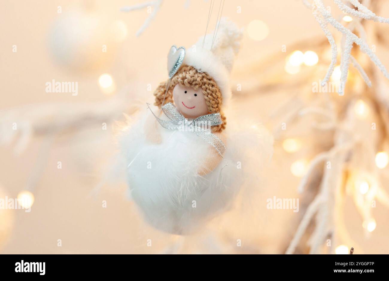 Pallina di natale con la pelliccia e un carattere con un po' di cuore. Tutto bianco e luci calde in stile shalby. Foto Stock