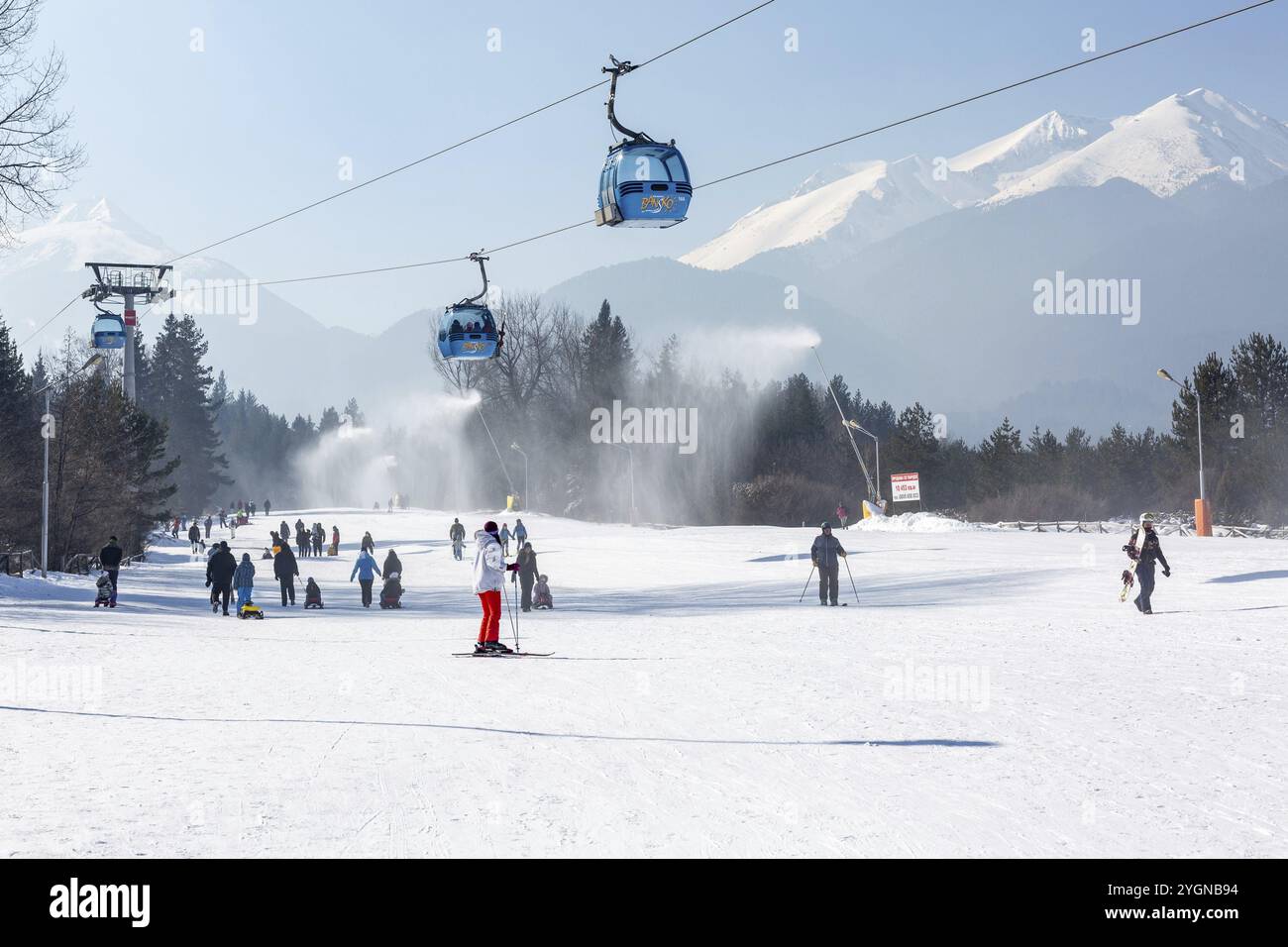 Bansko, Bulgaria, 11 febbraio 2023: Panorama della stazione sciistica invernale bulgara con cabine cabine di cabinovia, vista sulle cime dei monti Pirin e pista, Europa Foto Stock