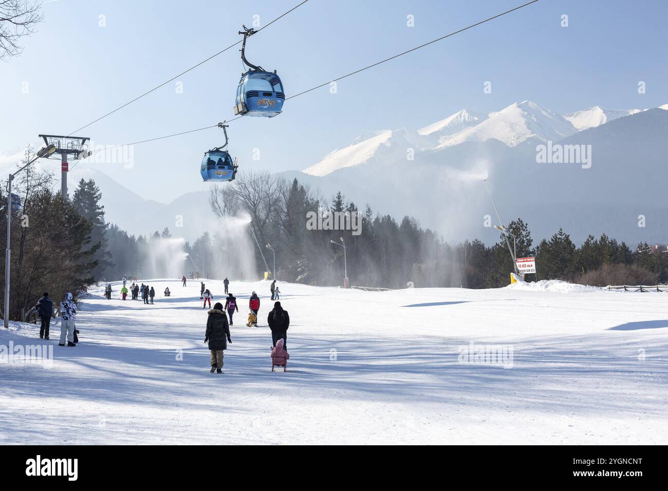 Bansko, Bulgaria, 11 febbraio 2023: Panorama della stazione sciistica invernale bulgara con cabine cabine di cabinovia, vista sulle cime dei monti Pirin e pista, Europa Foto Stock