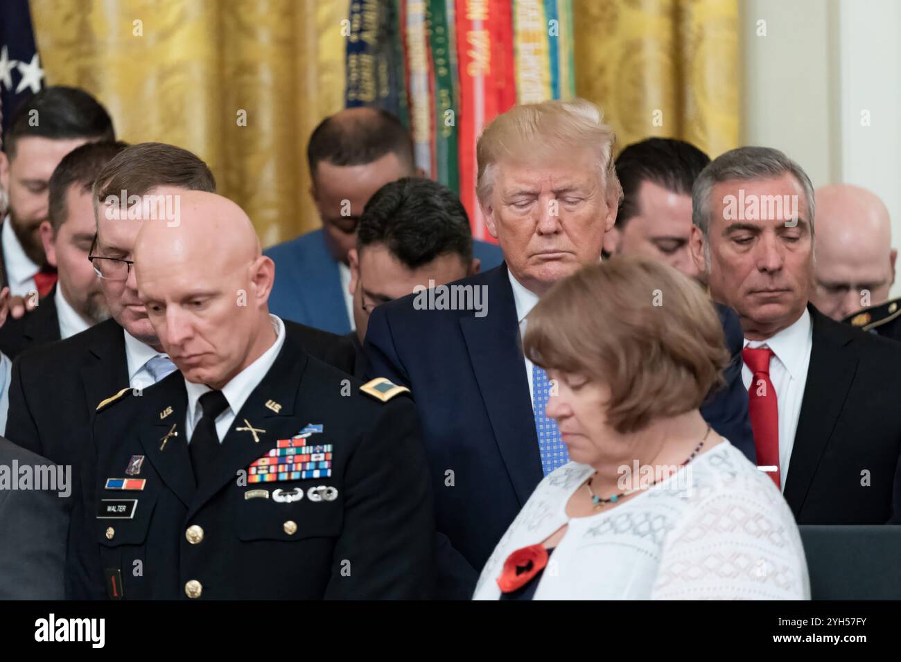 Washington, Stati Uniti d'America. 25 giugno 2019. U. Il presidente Donald Trump, al centro, rappresenta un momento di silenzio per onorare i morti di guerra dopo aver presentato la Medal of Honor al sergente David Bellavia, in pensione, durante una cerimonia nella sala orientale della Casa Bianca, il 25 giugno 2019 a Washington, DC. Bellavia ha ricevuto il più alto onore delle nazioni per le azioni intraprese durante la seconda battaglia di Fallujah. Crediti: Shealah Craighead/foto della Casa Bianca/Alamy Live News Foto Stock