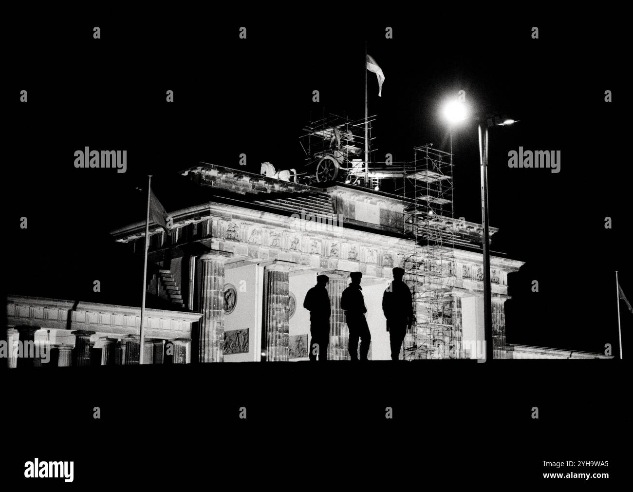 © John Angerson. Novembre 1989: I berlinesi orientali si inondano a Berlino Ovest, passando attraverso l'iconica porta di Brandeburgo, accolti con applausi, abbracci e lo storico Begrüßungsgeld o "Welcome Money". Folle gioiose celebrano la nuova libertà quando cade il muro di Berlino, segnando la fine di decenni di divisione." Foto Stock