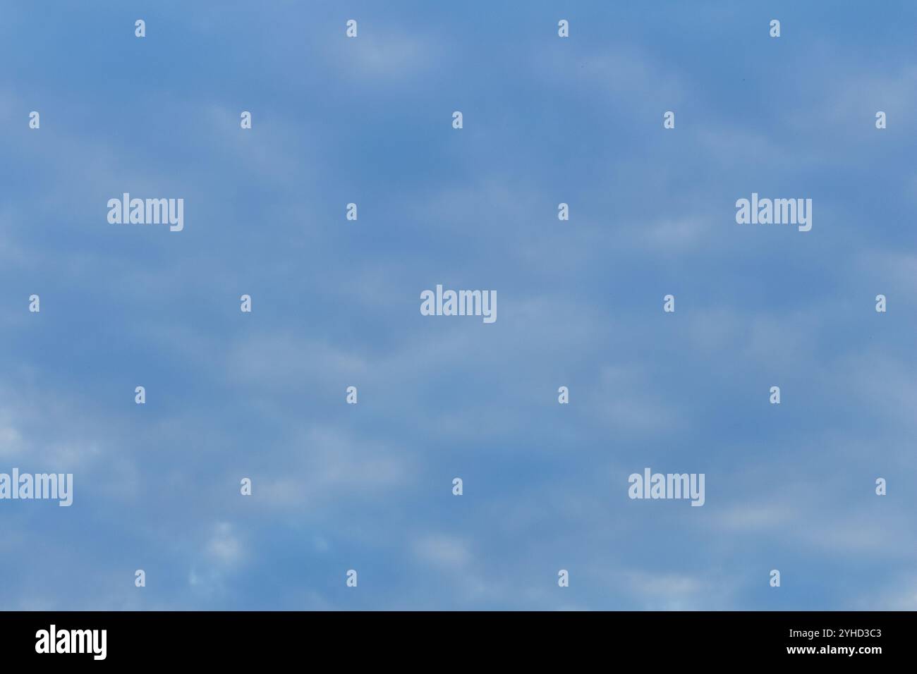 Cielo azzurro con nuvole altocumulus sparse che formano un motivo testurizzato in una giornata di sole Foto Stock