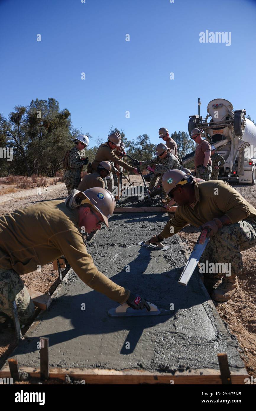 I marinai assegnati al Naval Mobile Construction Battalion (NMCB) 4 posizionano il cemento in un campo di qualificazione delle pistole durante un allenamento sul campo a ft. Hunter Liggett il 5 novembre 2024. L'NMCB 4 sta attuando un solido piano di formazione sulle competenze di costruzione per preparare una missione dinamica in tutto l'Indo-Pacifico a sostegno degli obiettivi strategici del Combatant Commander. (Foto della Marina degli Stati Uniti di Dakota Rayburn, specialista della comunicazione di massa di 1a classe) Foto Stock