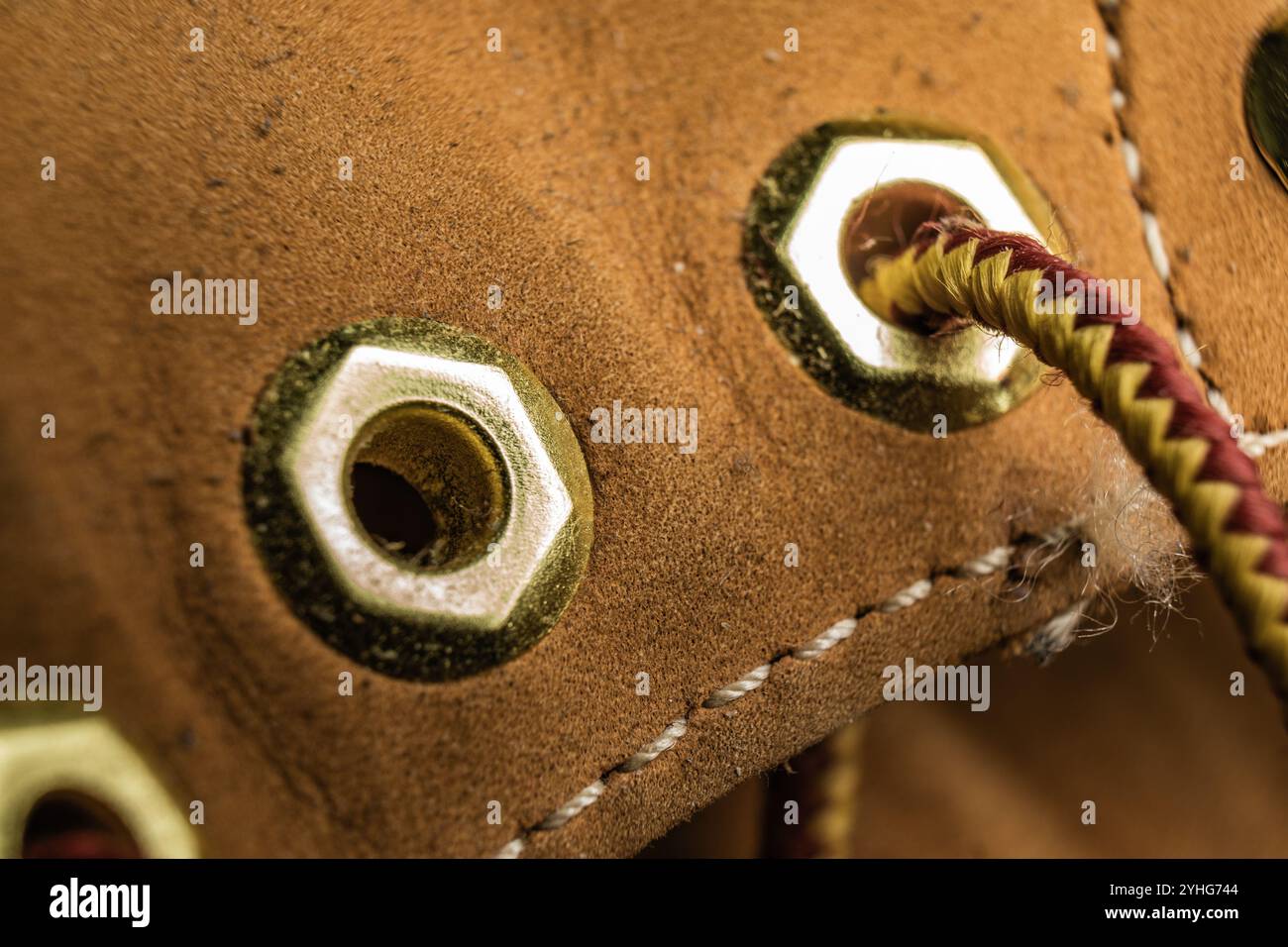 Primo piano di una scarpa che mette in risalto l'occhiello e il pizzo in un ambiente dalle tonalità calde Foto Stock