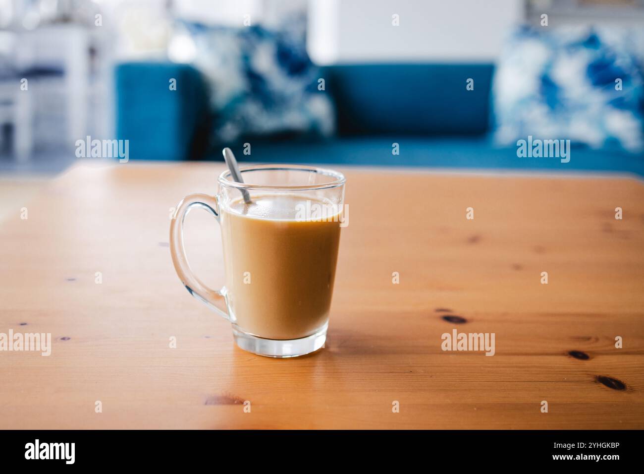 mano che tiene il caffè in una tazza trasparente davanti allo sfondo sfocato degli interni della casa, profondità di campo ridotta, abitudini e concetto di stile di vita Foto Stock mano che tiene il caffè in una tazza trasparente davanti allo sfondo sfocato degli interni della casa, profondità di campo ridotta, abitudini e concetto di stile di vita Foto Stock