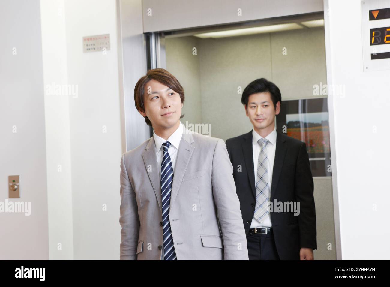 Uomo d'affari in uscita dall'ascensore Foto Stock