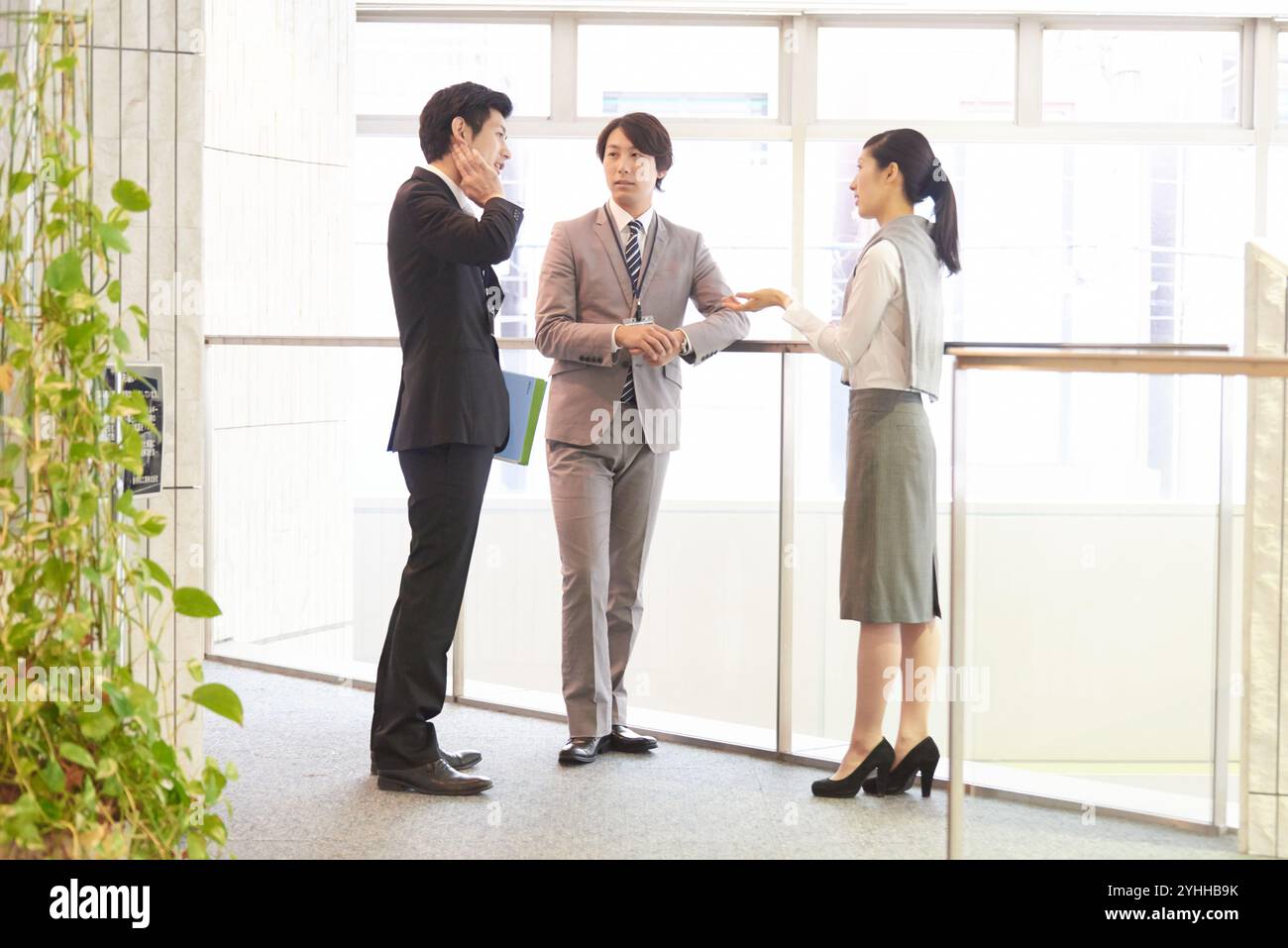 Uomo d'affari e collega che parlano in corridoio Foto Stock