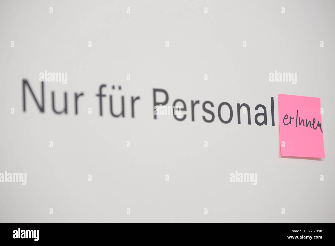 Auf einer Tür die mit Nur für Personal beschriftet ist, wurde ein Postit mit einer gegenderten form angeheftet *** su una porta etichettata solo per il personale Foto Stock