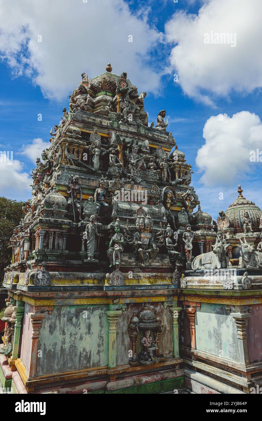 Una foto che cattura la grandezza di un edificio molto alto a Mauritius, adornato da una serie di statue dettagliate. Foto Stock