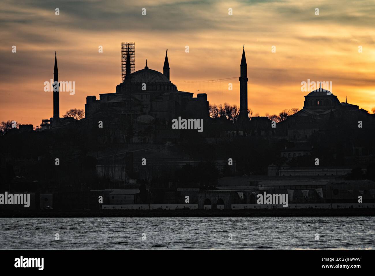 Splendido tramonto alla sagoma del minareto della moschea del Bosforo, barche sull'acqua nella zona Sultanahmet di Istanbul in Turchia Foto Stock