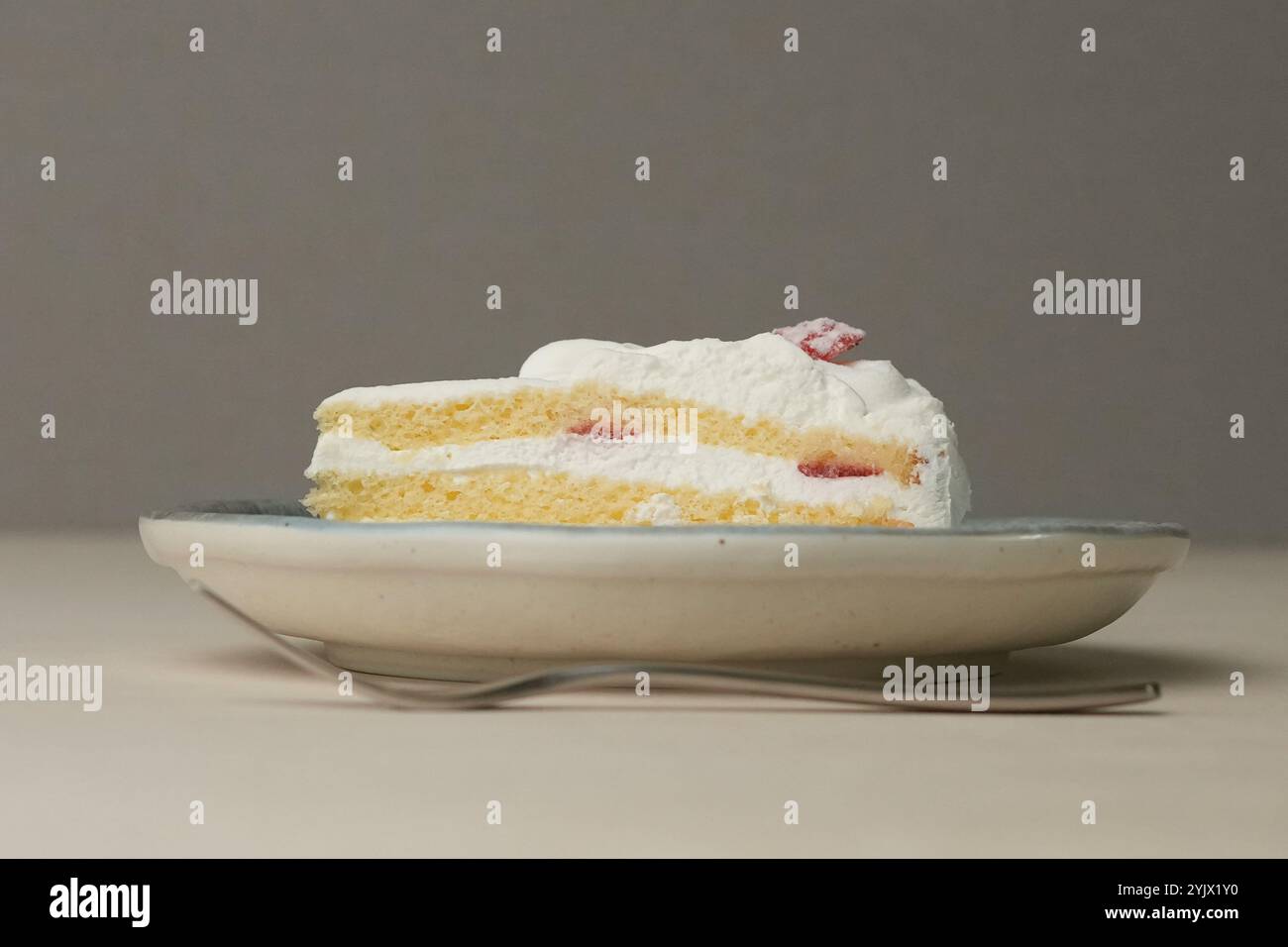 Shortcake e forchetta di fragole giapponesi su ogni piatto grande e piccolo su un tavolo di legno. Foto Stock