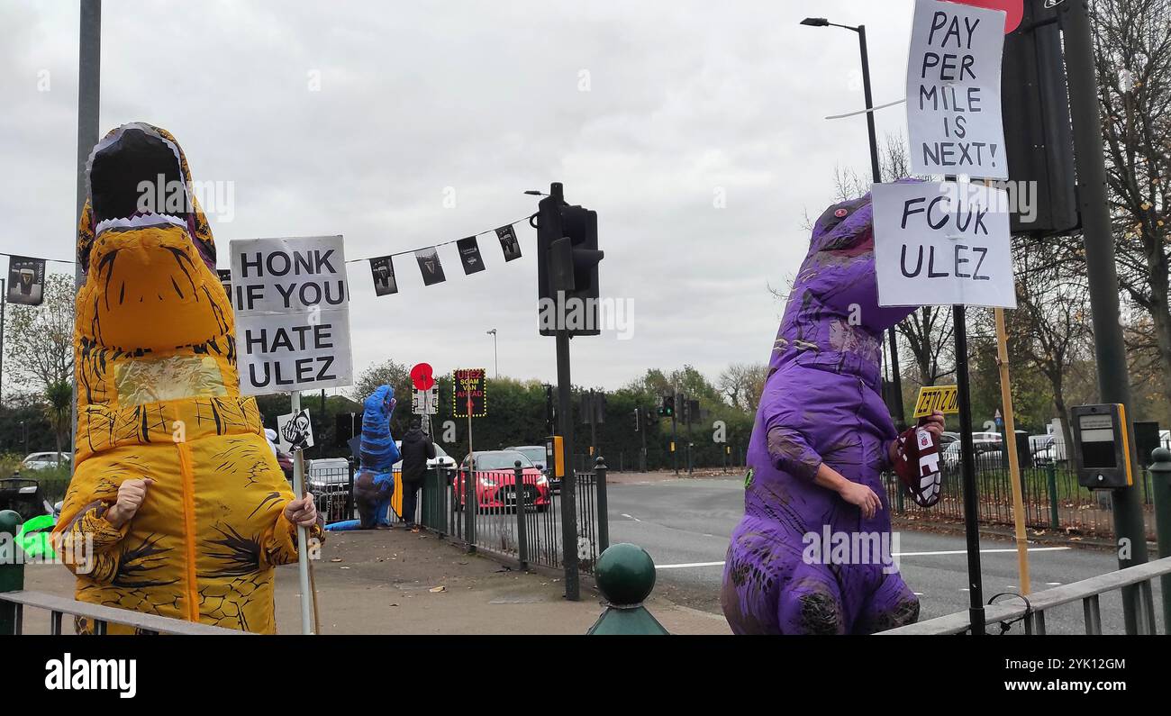 Twickenham, Regno Unito. 16 novembre 2024. Aeroporto internazionale di Autunno. Inghilterra V Sud Africa. Stadio Allianz. Twickenham. I manifestanti anti anti-ULEZ vestiti da dinosauri hanno striscioni che dicono "Hok if you hate ULEZ" e "Pay per Mile is Next" in una rotatoria vicino all'Allianz Stadium di Twickenham prima della partita di rugby England V South Africa Autumn International all'Allianz Stadium di Londra, Regno Unito. Crediti: Sport in foto/Alamy Live News Foto Stock