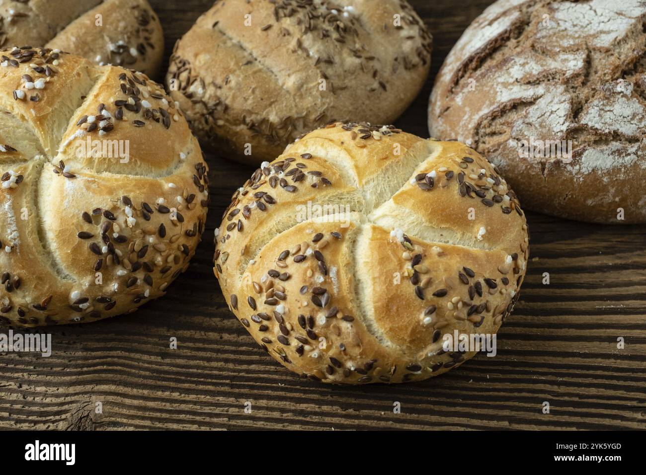 Pane diverso su fondo rustico in legno. Assortimento di pane da forno Foto Stock