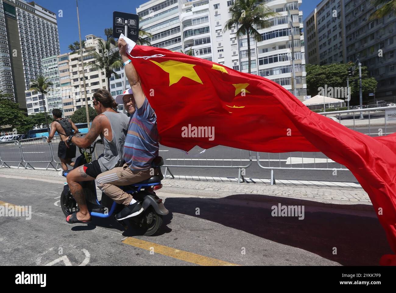 Rio De Janeiro, Brasile. 18 novembre 2024. Un uomo sventola una bandiera cinese dal retro di uno scooter a Copacabana. I leader delle più grandi economie del mondo si stanno riunendo in Brasile per il vertice del G20 che ha preso il via lunedì. (Immagine di credito: © Bob Karp/ZUMA Press Wire) SOLO PER USO EDITORIALE! Non per USO commerciale! Foto Stock